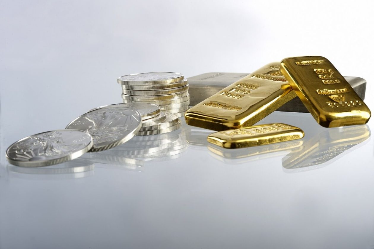 gold bars next to silver coins